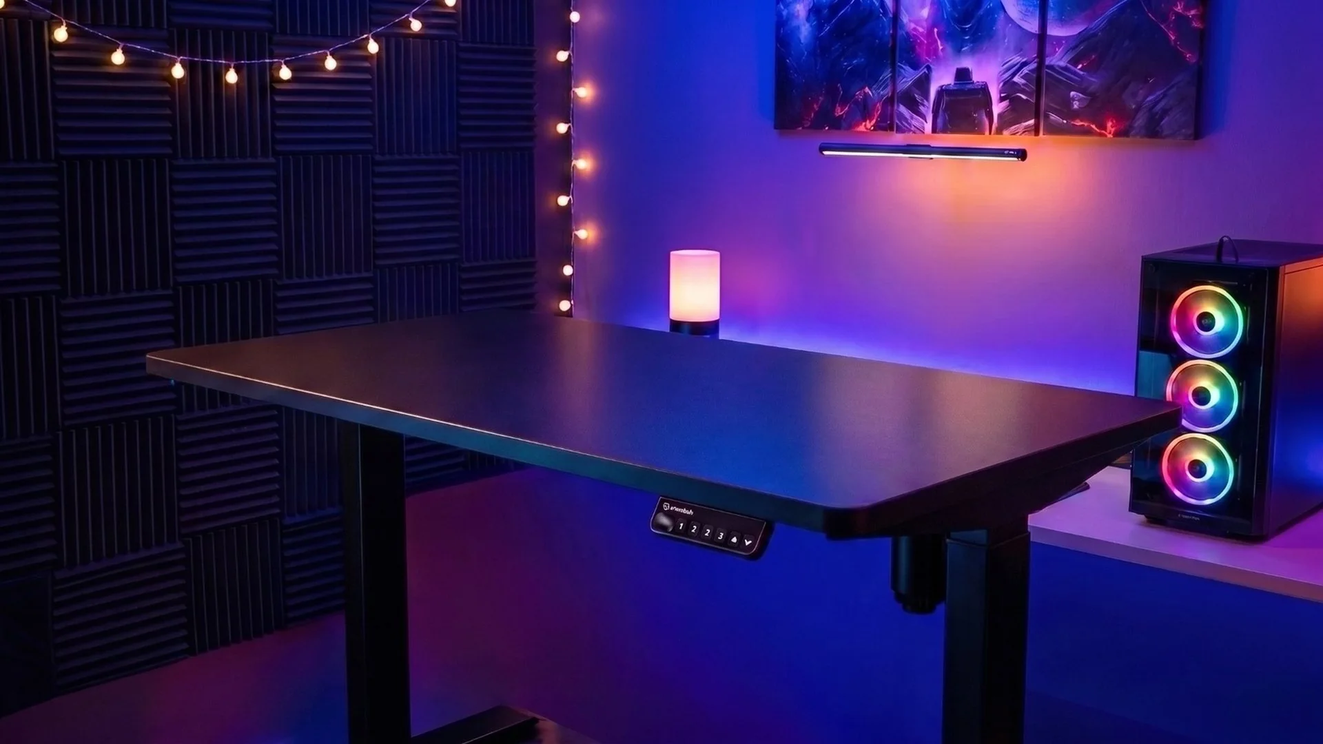 Interdesk Classic standing desk in a moody RGB gaming room with ambient lighting and a desktop PC