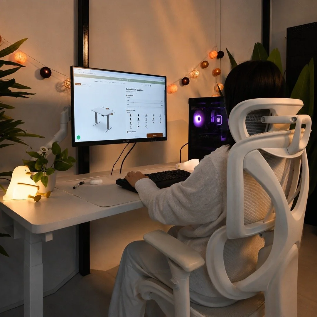 Warm home workspace with an Interdesk Custom setup and white ergonomic chair