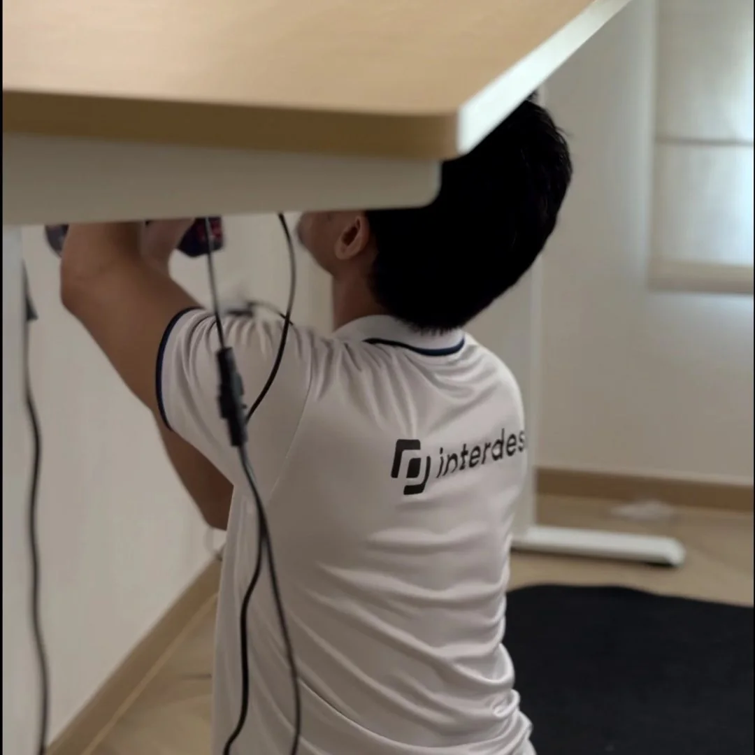An Interdesk team member carrying out on-site desk setup and installation