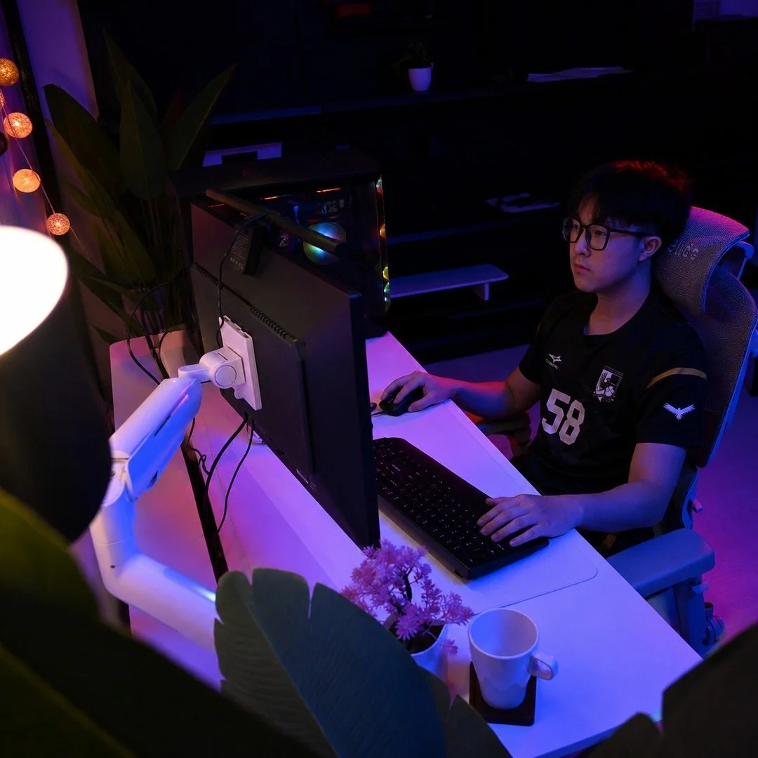 RGB-lit Interdesk setup with a monitor arm, gaming PC and ergonomic chair